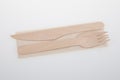 Wood tableware wooden fork knife and recycled napkin recyclable on white background Royalty Free Stock Photo