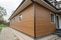 Wood texture composite cladding installation on house facade Royalty Free Stock Photo
