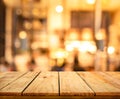 Wood texture table top counter bar with blur light gold bokeh in cafe,restaurant background Royalty Free Stock Photo