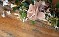 Bouquet of white flowers and fabric flower in corner. Wooden background. Copy Space