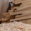 Wood timber construction material for background and texture. close up. wood shavings and Stack of wooden bars blurred on backgrou Royalty Free Stock Photo