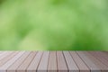 Wood top table, plank on blurred green nature background. For montage or display your products. Empty space