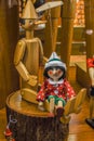 Wood toy Pinocchio. Workshop where the master scrutinizes the handmade wooden toys of Pinocchio