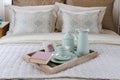 Wood tray of tea cup set and book on bed Royalty Free Stock Photo