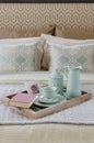 Wood tray of tea cup set and book on bed Royalty Free Stock Photo