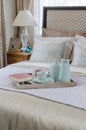 Wood tray of tea cup set and book on bed Royalty Free Stock Photo