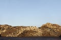 Wood tree logs stacked and chopped against empty clear blue sky Royalty Free Stock Photo