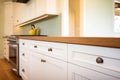 wood trim details on white kitchen cupboards Royalty Free Stock Photo