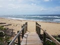 wood walkway or path to beach with ocean Royalty Free Stock Photo