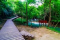 Wood walkway on a wild park to the Waterfall Huay Mae Kamin Royalty Free Stock Photo