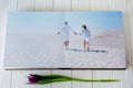 Wood wedding photo book. Happy young couple in love. Bride and groom walking of wedding day.