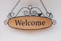 Wood welcome sign hanging on wall