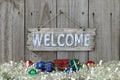 Wood welcome sign with holiday garland border