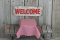 Wood welcome sign over picnic table