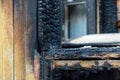 The wood window after seroius fire. The wooden building after fire.