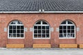 Wood windows with red bricks wall arched windows