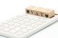 Wood word VAT and Wood Heart placed on a white calculator as background finance concept and business concept Royalty Free Stock Photo