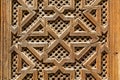 Wood work in a square pattern on the doors of a madarsa in Fes, Morocco.