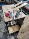 sanding machine and other tools on a wooden table in a wood workshop