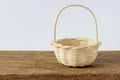 Wood woven basket on wooden table and white background.