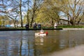 Woodbridge, Suffolk, UK April 12 2021: Old friends meeting up and sailing their model yachts on a pond