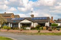 Woodbridge, Suffolk, UK April 30 2021: A small traditional bungalow with solar panels on the roof. Green energy solar energy