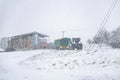 Woodbridge Suffolk UK February 07 2021: Farm workers trying to take a delivery while fighting against a heavy snow storm and