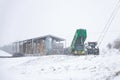 Woodbridge Suffolk UK February 07 2021: Farm workers trying to take a delivery while fighting against a heavy snow storm and