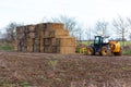 Woodbridge, Suffolk, UK January 17 2021: Stacked Square Yellow Hay Bales on a farm field ready to be laid to protect crops from Royalty Free Stock Photo