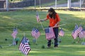 Volunteers placing an American Flag on the grave of a Military Veteran for Memorial Day