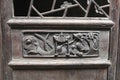 Woodcarving decorations with a dragon at an ancient timber door, Daxu, China