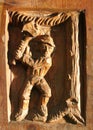 Woodcarving of man chopping tree
