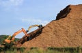 Woodchip Mountain with Backhoes working