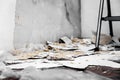 Woodchip wallpaper is removed or scraped off the wall, leftovers lie on the floor Royalty Free Stock Photo