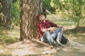 Woodcutter with axe in the summer forest. Illegal logging continues today. Lumberjack standing with axe on forest Royalty Free Stock Photo