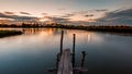 Wooded bridge in the port at sunset. Royalty Free Stock Photo