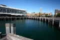 Harbor with curved boardwalk and historic heritage buildings on waterfront in Woolloomooloo Bay, Sydney, Australia