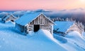 Wooden abandoned cabin in winter mountains at sunrise Royalty Free Stock Photo