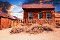 Wooden abandoned house in the desert at sunset Royalty Free Stock Photo