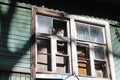 Wooden abandoned house without tenants. Old building. Broken window close-up Royalty Free Stock Photo