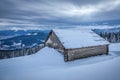 Wooden abandoned hut, cabin in winter mountains after sunset Royalty Free Stock Photo