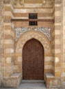 Wooden aged grunge door and stone bricks wall, one of the exterior doors of the Blue Mosque, Bab El-Wazir District, Cairo, Egypt Royalty Free Stock Photo