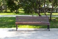 Wooden alone bench in the park against .