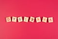 Wooden alphabet blocks with DYSLEXIA word on pink background