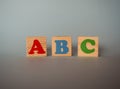 Wooden alphabet toy blocks with the text: abc. Isolated kids multi-colored ABC cubes on blue background Royalty Free Stock Photo