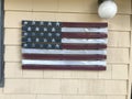 Wooden american flag attached to a house