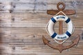 Wooden anchor and life bouy on wood pattern old nature table board Royalty Free Stock Photo