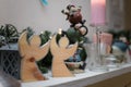 Wooden angel shaped toys standing on the fireplace on blurry toys background. Merry Christmas and winter holidays