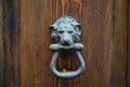A wooden antique door and an iron lion handle Royalty Free Stock Photo