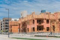 Wooden apartment complex under construction near completed condos and commercial building Royalty Free Stock Photo